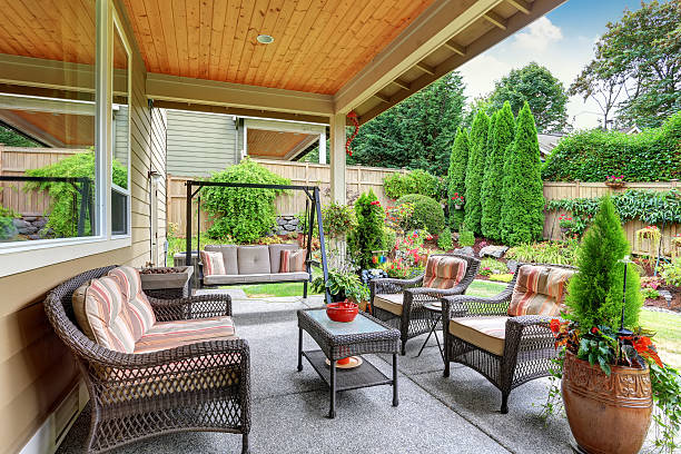 Cozy covered sitting area with wicker chairs and swing bench. Northwest, USA